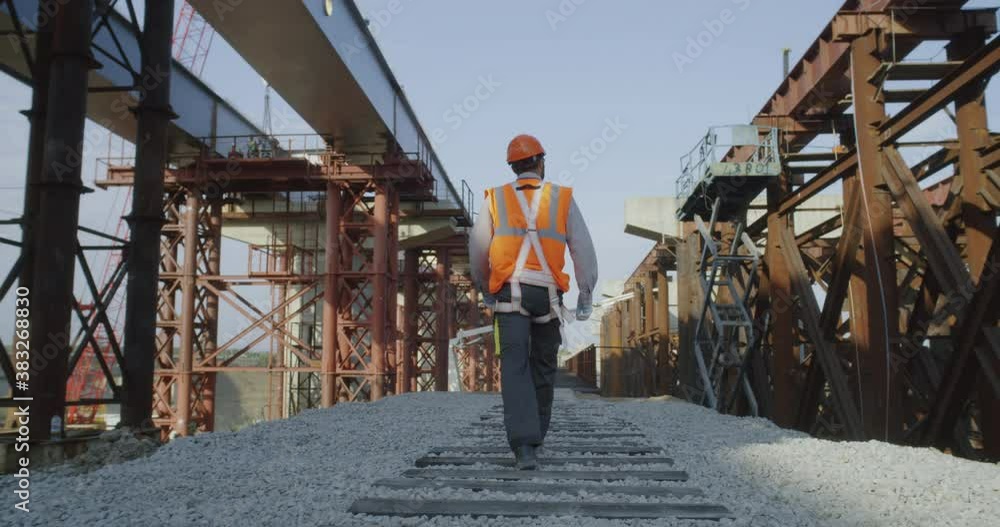 Unrecognizable builder walking on construction site