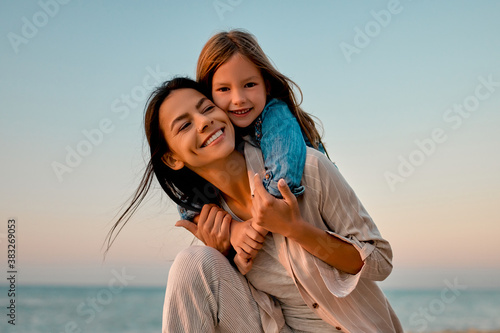 Mother with daughter on the beach photo