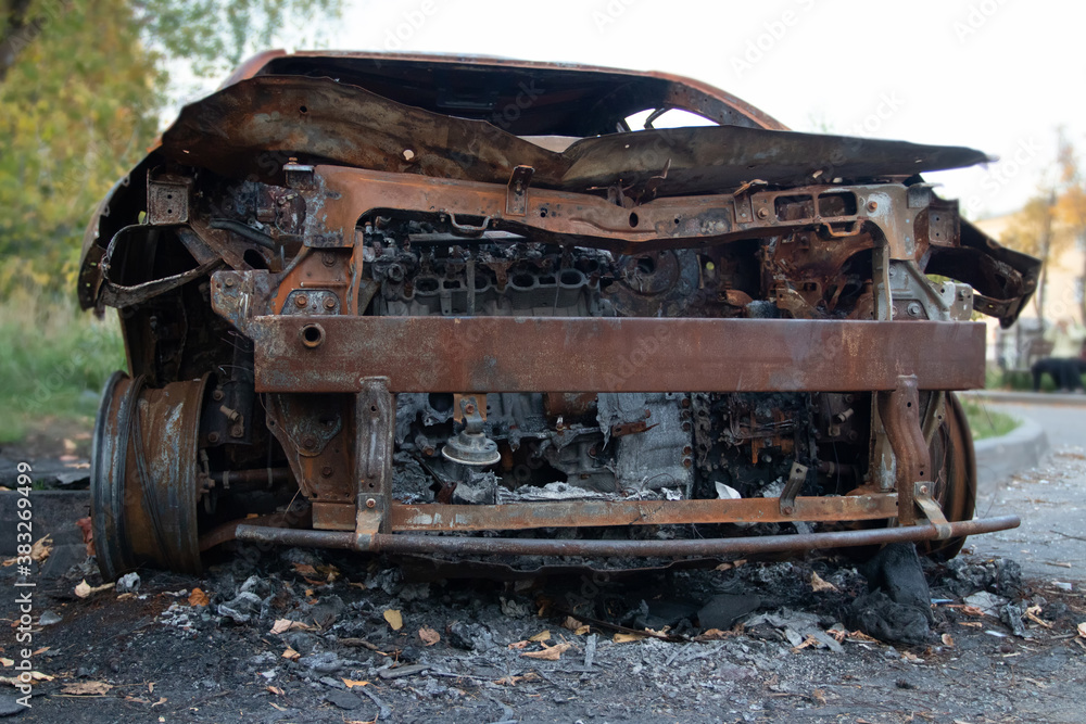 car in a parking lot burned by vandals