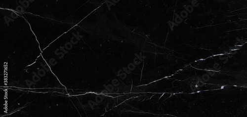 Luxurious black agate marble texture with white veins, polished marble quartz stone background striped by nature with a unique patterning, granite marble stone ceramic tile surface.