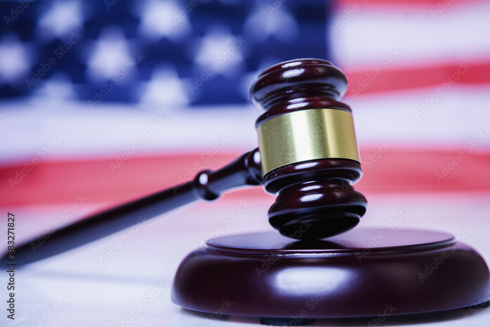 Judge gavel against United States national flag as symbol of judicial system of the USA. Justice, equity, law and human freedom concept. Horizontal image. Judge gavel against United States national flag as symbol of judicial system of the USA. Justice, equity, law and human freedom concept. Horizontal image.