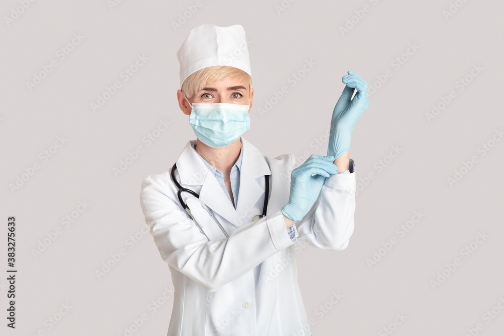 Reception and examination by doctor and modern treatment in clinic. Middle aged woman puts on rubber gloves Reception and examination by doctor and modern treatment in clinic. Middle aged woman puts on rubber gloves