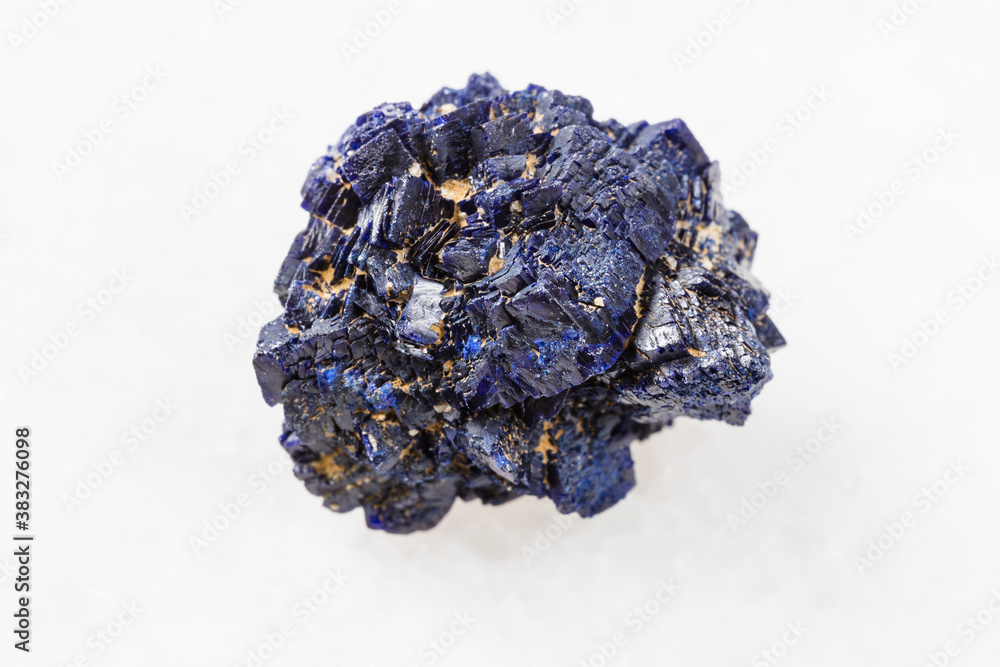macro photography of sample of natural mineral from geological collection - unpolished Azurite mineral crystals from Jezkazgan, Kazakhstan on white marble background macro photography of sample of natural mineral from geological collection - unpolished Azurite mineral crystals from Jezkazgan, Kazakhstan on white marble background