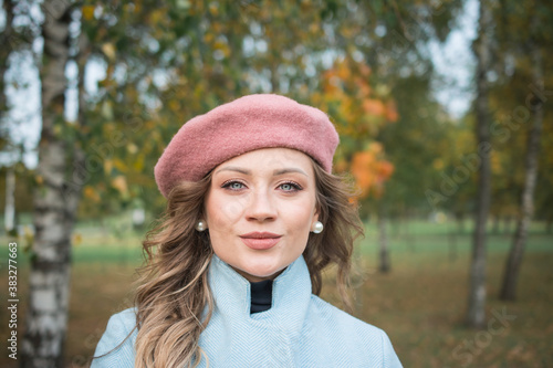 Beautiful girl in a blue coat and beret
