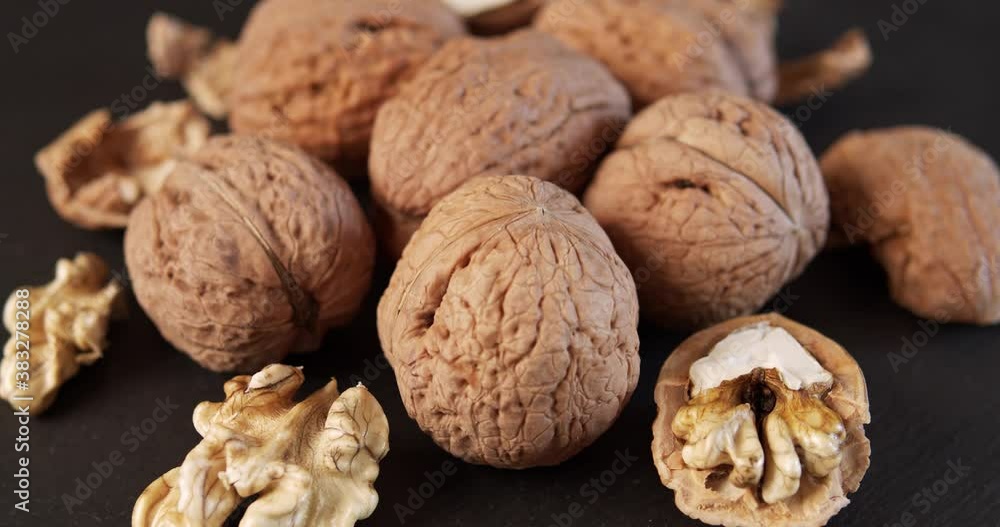 delicious and fresh walnuts on a black stone table delicious and fresh walnuts on a black stone table