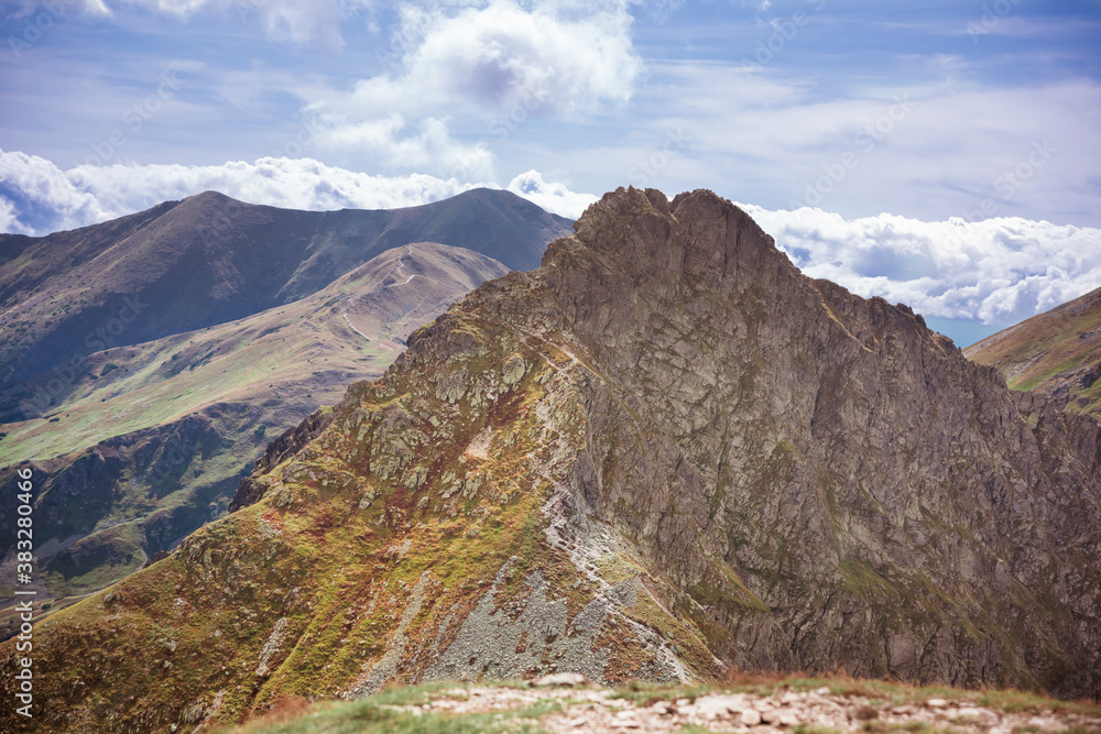 Dangerous mountains - steep and narrow path on a ridge to rocky summit of Rohacz Ostry - obrazy, fototapety, plakaty 