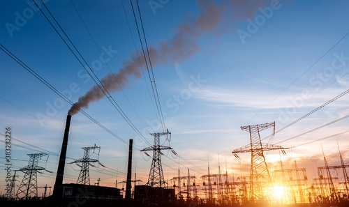 Thermal power stations and power lines during sunset.