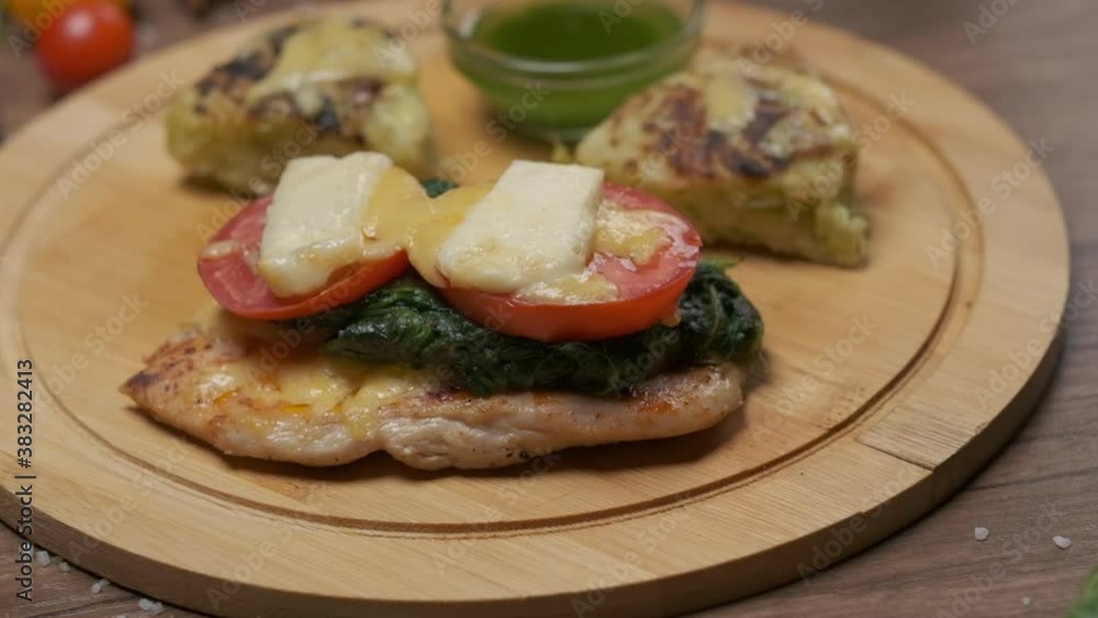 Grilled vegetables with cheese on the round serving board with green oil Grilled vegetables with cheese on the round serving board with green oil
