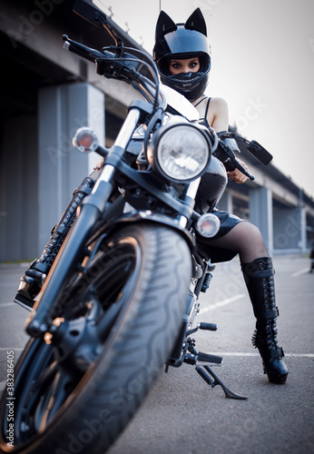 A sexy girl sitting on a bike.