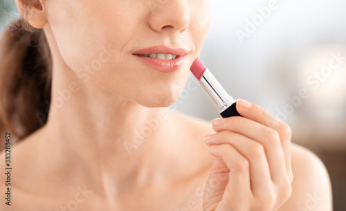 Cropped of woman using lipstick  copy space