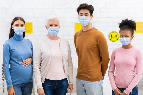 Covid-19 Vaccinated Diverse Patients In Face Masks Standing In Hospital
