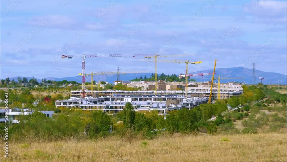 construction cranes and operators working on the creation of a new residential neighborhood construction cranes and operators working on the creation of a new residential neighborhood