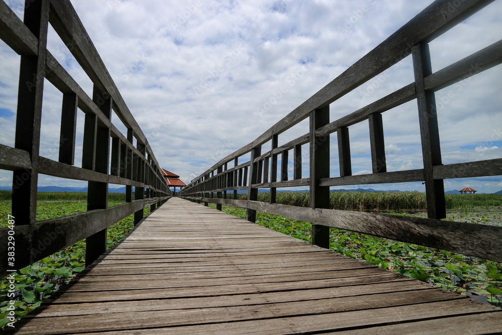 Lake views with wooden bridges, pavilions and mountains. Tourist attractions in Thailand.