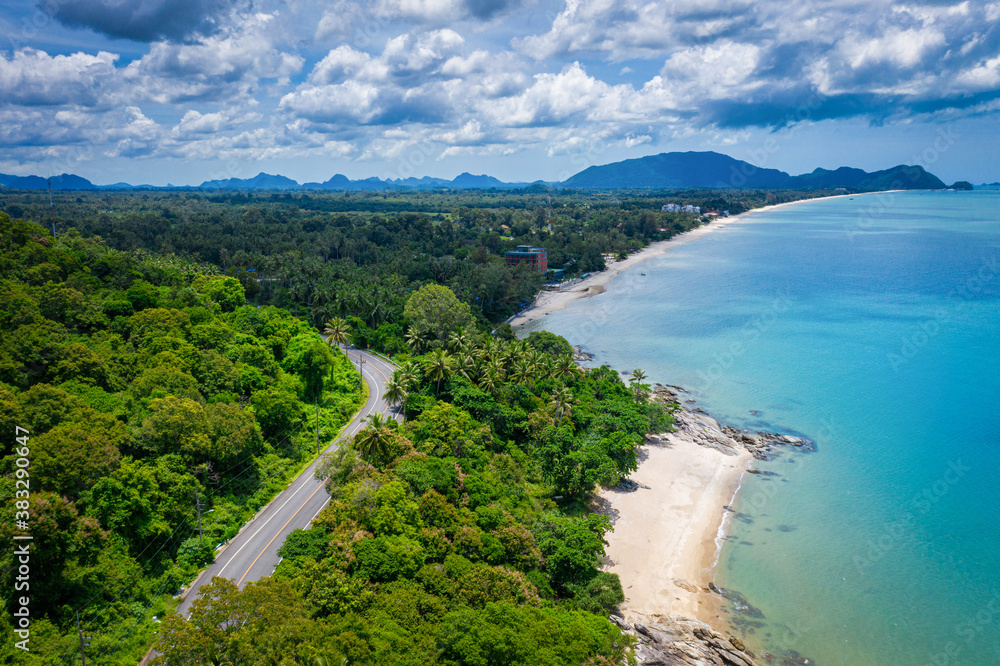 Aerial view of road between coconut palm tree and great ocean at daytime in Nakhon Si Thammarat, Thailand Aerial view of road between coconut palm tree and great ocean at daytime in Nakhon Si Thammarat, Thailand