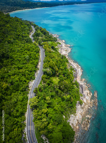 Fotografija Aerial view of road between coconut palm tree and great ocean at daytime in Nakh