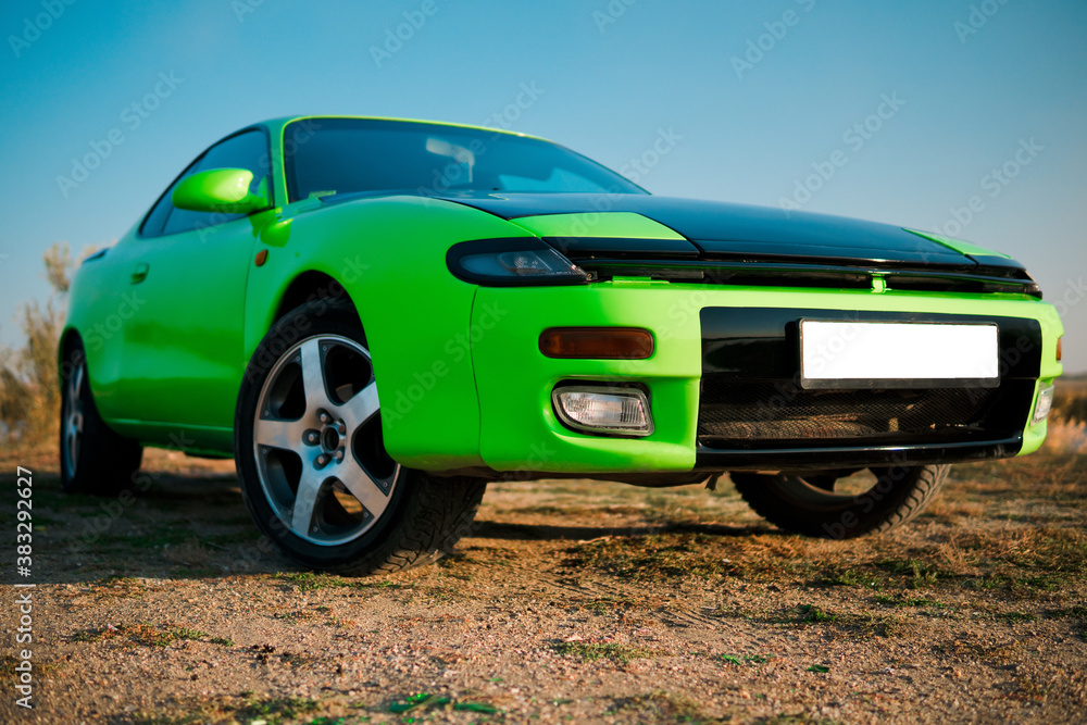 Green and black sport coupe car with big wheels. Japanese oldtimer. Green and black sport coupe car with big wheels. Japanese oldtimer.