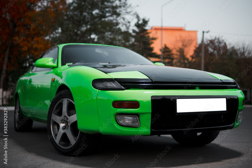 Green and black sport coupe car with big wheels. Japanese oldtimer. Green and black sport coupe car with big wheels. Japanese oldtimer.