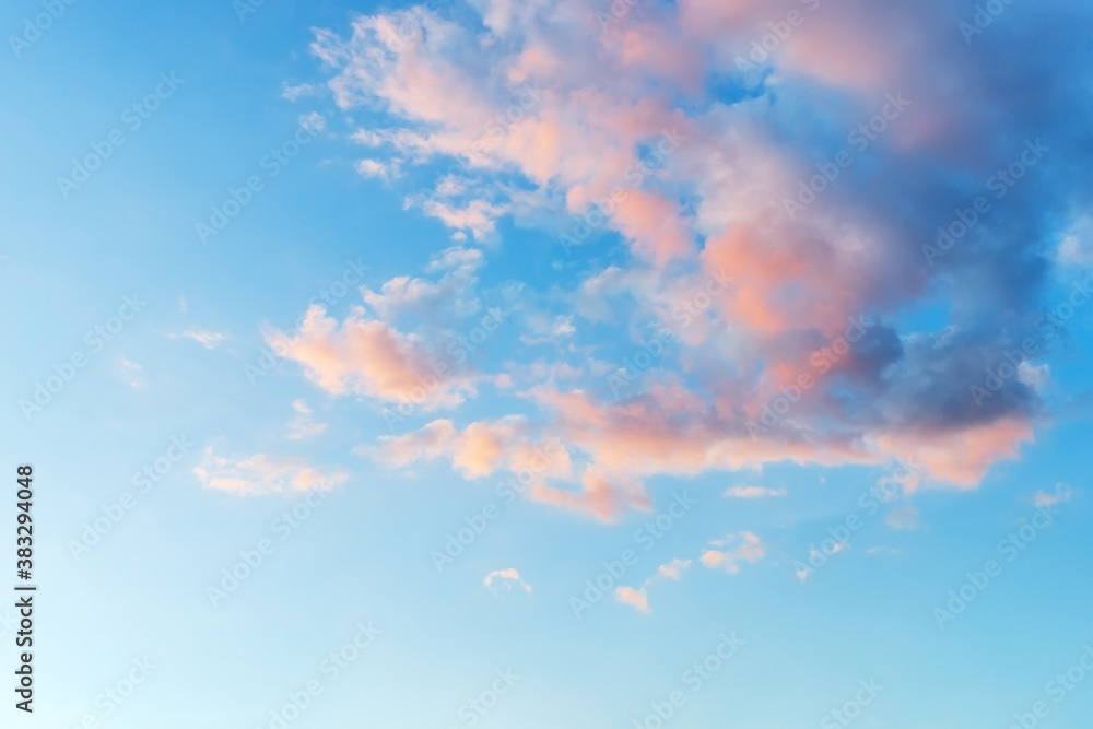 Vanilla sky. Azure sunset sky with light pink clouds. Tranquil skyscape just before the sundown. Pastel colored heaven for romantic mood background.