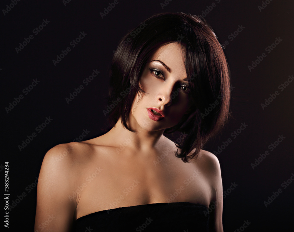 Alluring portrait of short bob hair style woman looking down on black background. Closeup art portrait. Alluring portrait of short bob hair style woman looking down on black background. Closeup art portrait.