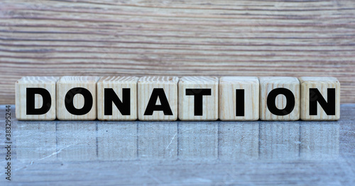 DONATION - word on wooden cubes on a gray background