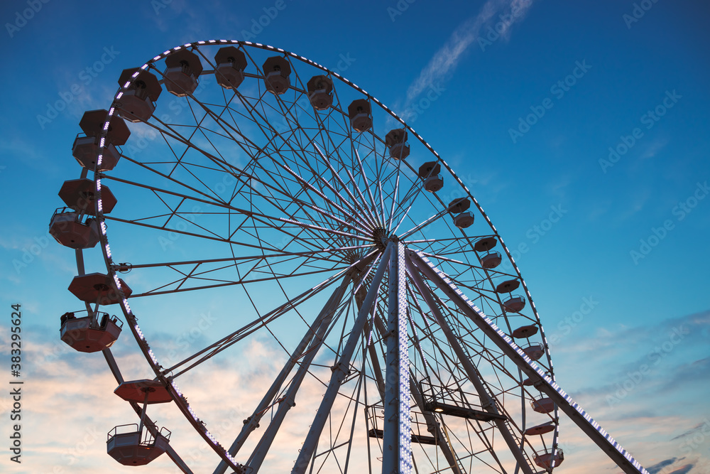 Ferris Wheel with sunset sky and clouds