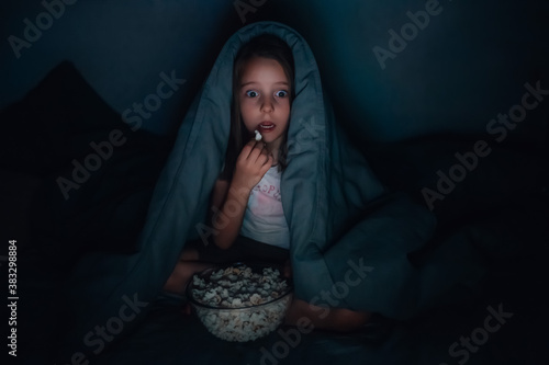 Little girl watches horror movie