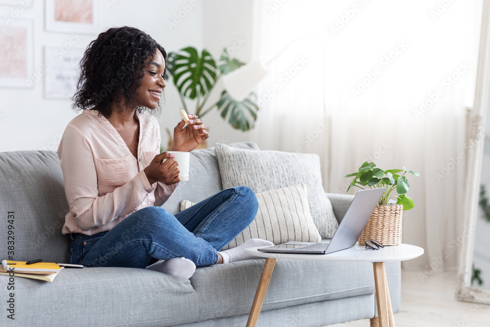 Free Time At Home. Smiling African Woman Relaxing With Coffee And Laptop
