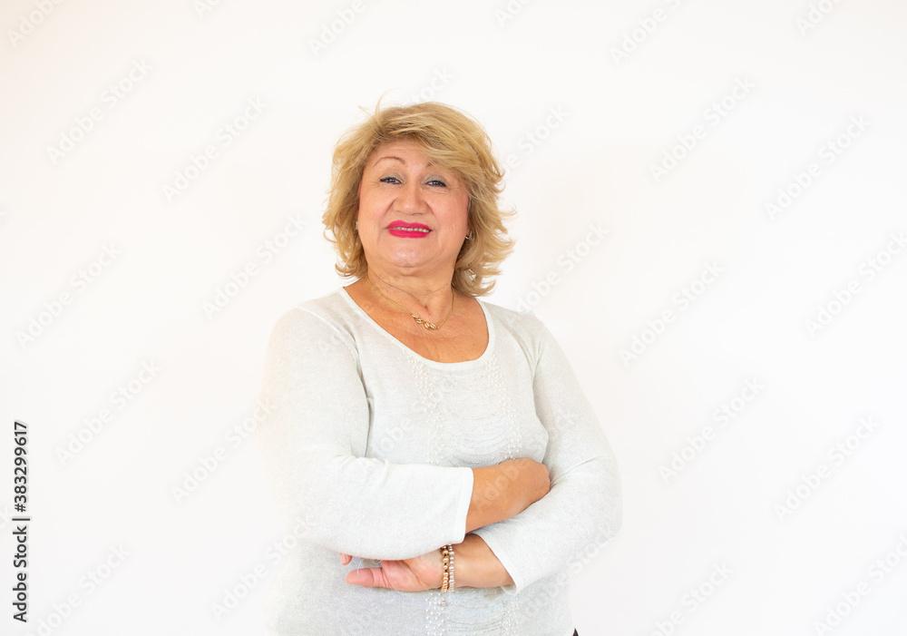 Smiling old senior woman with her arms crossed over white background Smiling old senior woman with her arms crossed over white background
