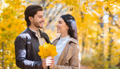 Couple of lovers with bunch of yellow marple leaves © Prostock-studio