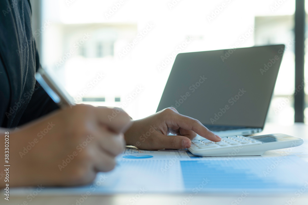 The Asian female finance staff is pressing a calculator to check the Company's financial investment results. To summarize and prepare to report the results to the meeting, Concepts of calculation The Asian female finance staff is pressing a calculator to check the Company's financial investment results. To summarize and prepare to report the results to the meeting, Concepts of calculation