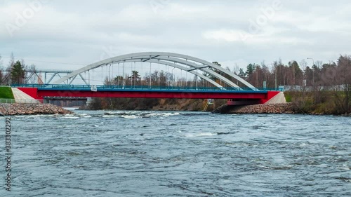 Time-lapse video with zooming. View of the Vuoksi River Bridge with traffic and the Vuoksi River flow in cloudy autumn day, Losevo, Leningrad Oblast, Russia
 photo