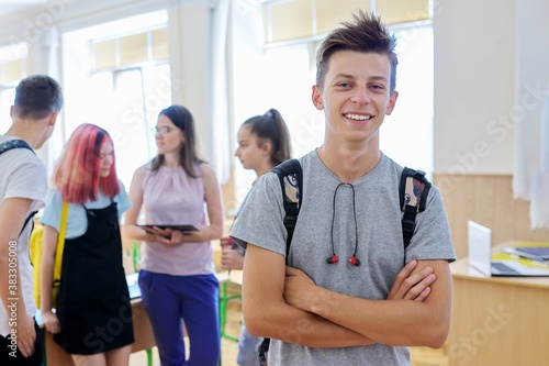 Portrait of smiling teenage boy in class on break photo