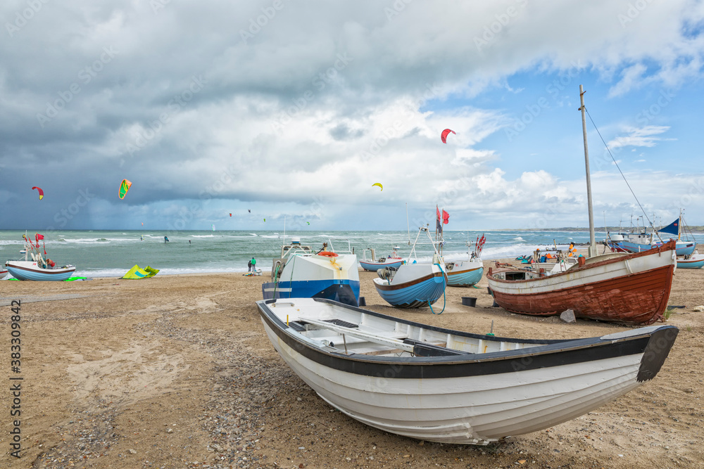 Beach of Nørre Vorupør, Denmark, with boats and kite surfers