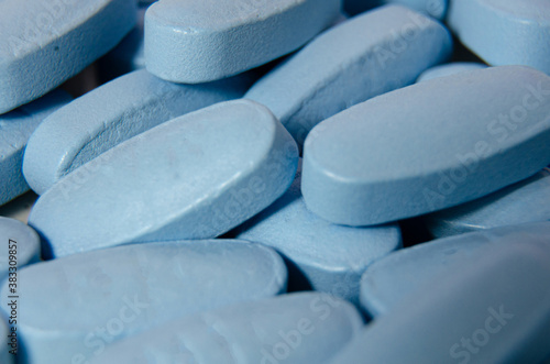 Close up view of blue vitamin pills.