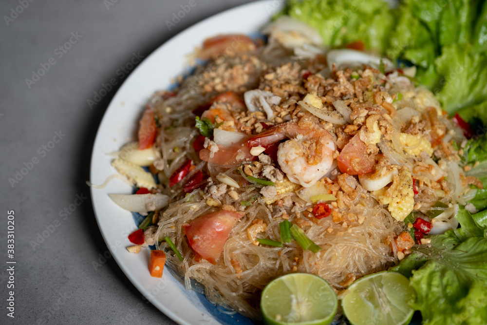 Spicy vermicelli salad with seafood, fresh vegetables.(Thai called Yum Woon Sen). Spicy vermicelli salad with seafood, fresh vegetables.(Thai called Yum Woon Sen).