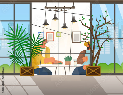 Friends are sitting in cafe or restaurant at a table eating and drinking. Cheerful men in glasses having fun, talking, communicating. Meeting good friends. View from the street through a large window