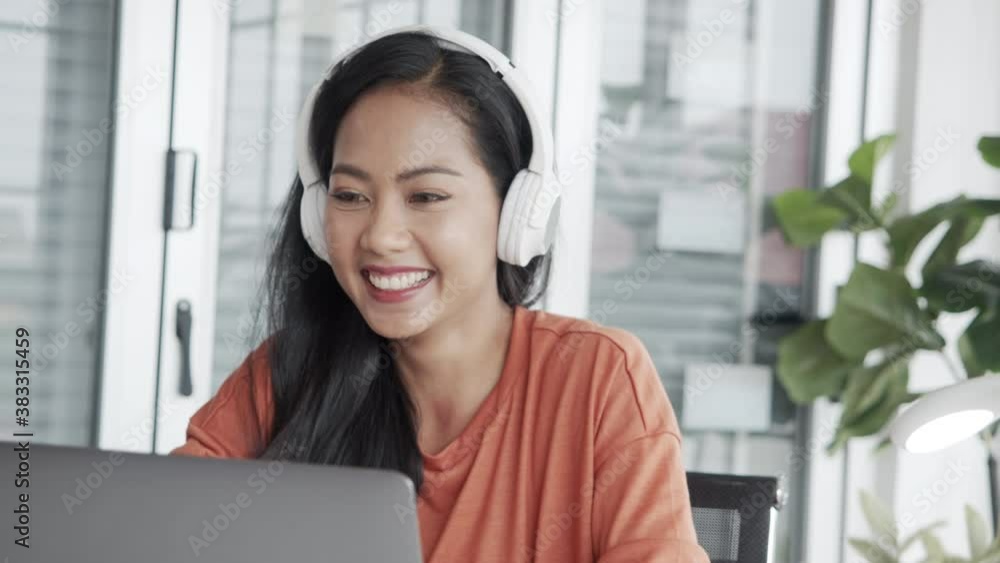 Excited asian teen girl celebrating success victory after receive good career job results email news on a laptop while sitting at her office. Excited asian teen girl celebrating success victory after receive good career job results email news on a laptop while sitting at her office.