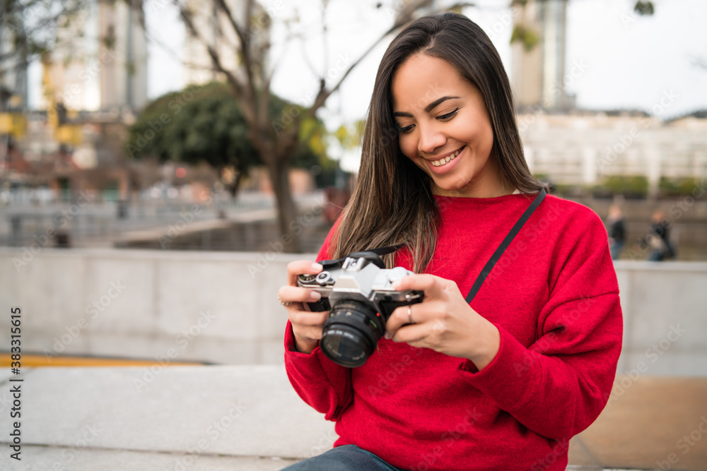 Young woman using a professional camera. Young woman using a professional camera.
