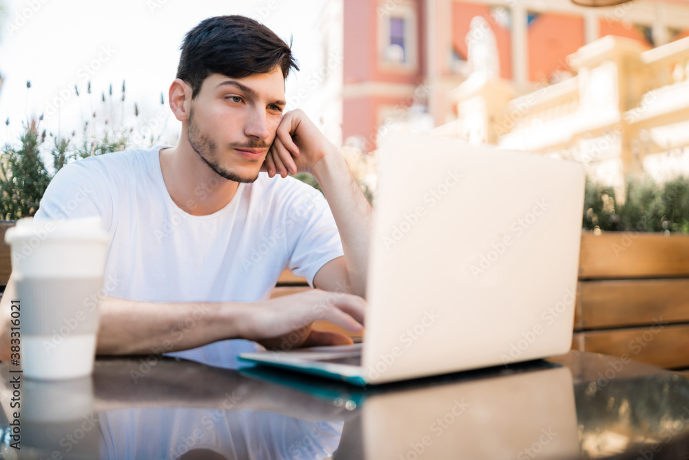 © Mego-studio - Young man using his laptop in a coffee shop. © Mego-studio - Young man using his laptop in a coffee shop.