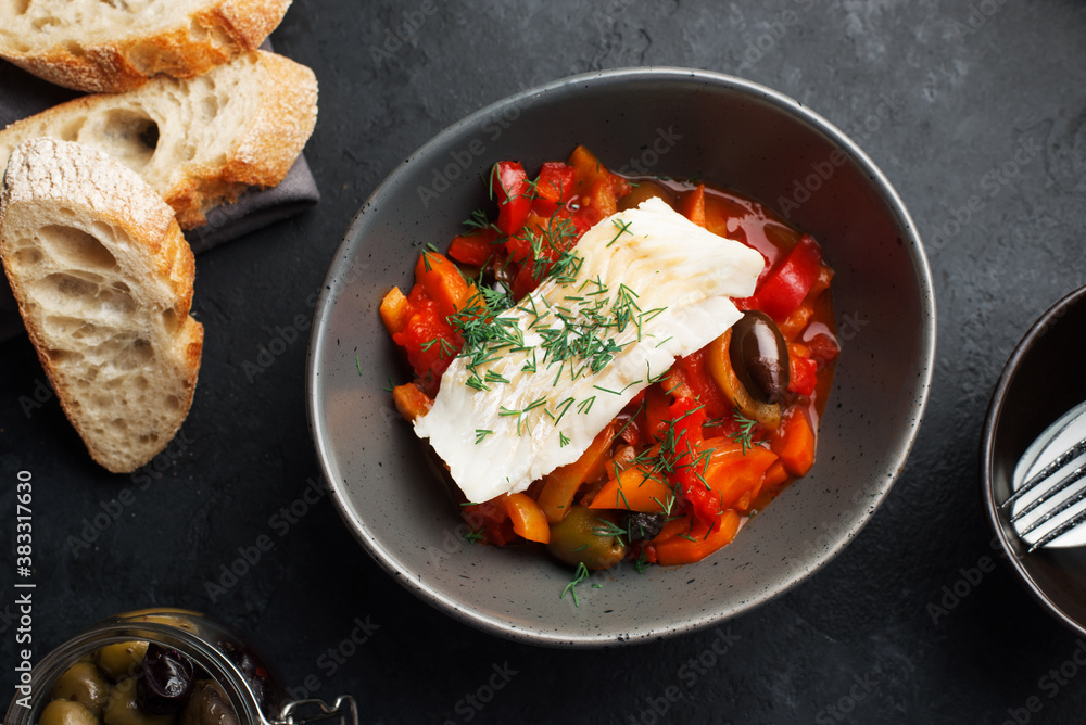 Delicious fish stew in paprika, tomatoes and white wine. Cod fillet