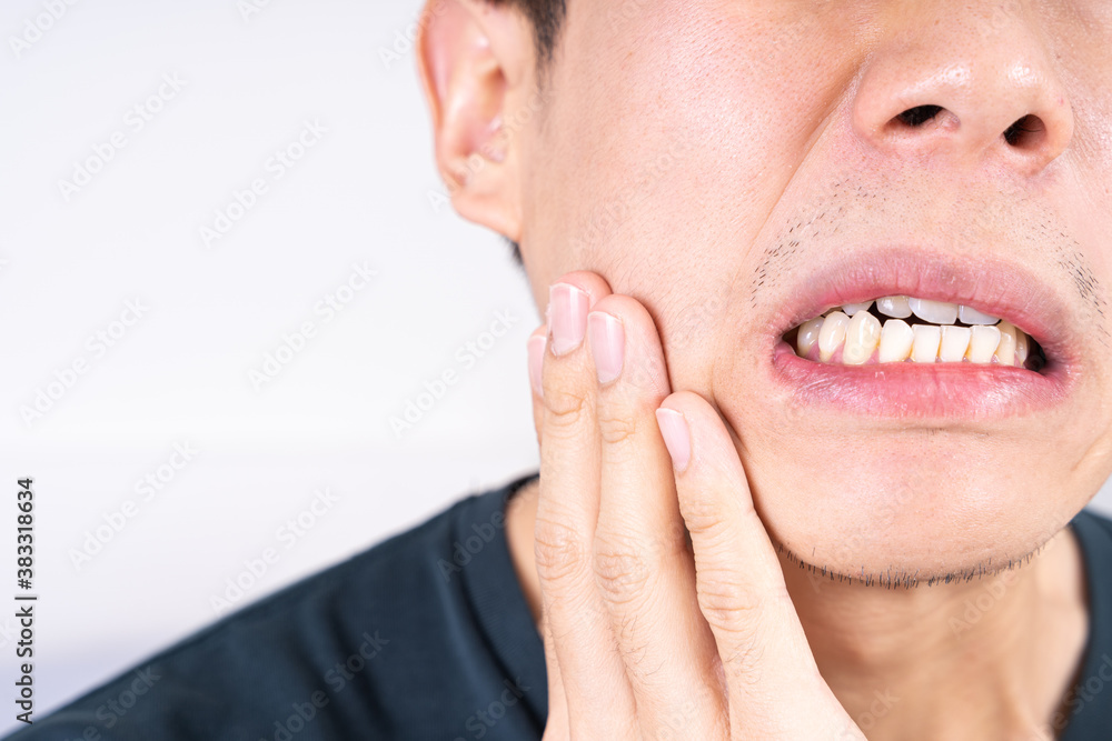 Obraz premium Man suffering from toothache, hand touching wisdom tooth. Dental, healthcare concept