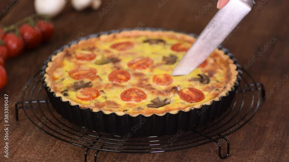 Cutting homemade quiche lorraine with chicken, mushrooms and cheese. French cuisine. Cutting homemade quiche lorraine with chicken, mushrooms and cheese. French cuisine.