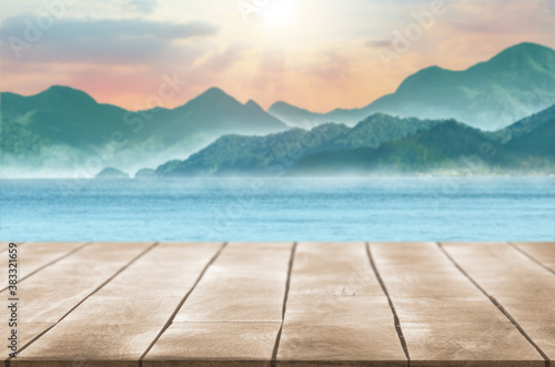 empty wooden table top surface with mountain lake water and cloud sky montage photo for advertisement display background © OHishi_Foto