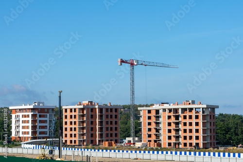Tower crane at a construction site. Construction of multi-apartment high-rise buildings. New building © NataliaSavilova