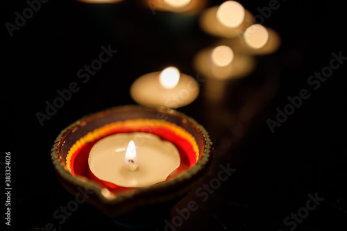 Happy Diwali day. Colorful traditional oil lamp diya on dark background.
