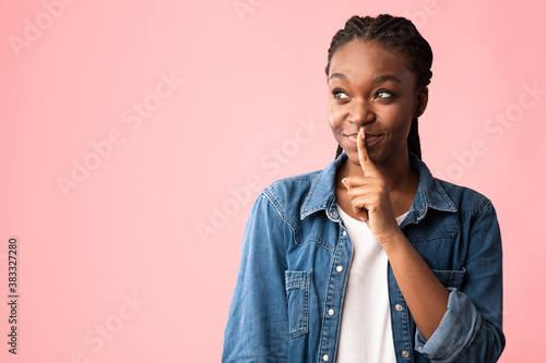 African Young Woman Gesturing Keep Silence Looking Aside, Pink Background