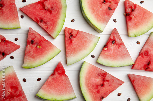 Watermelon slices on white wooden background, flat lay