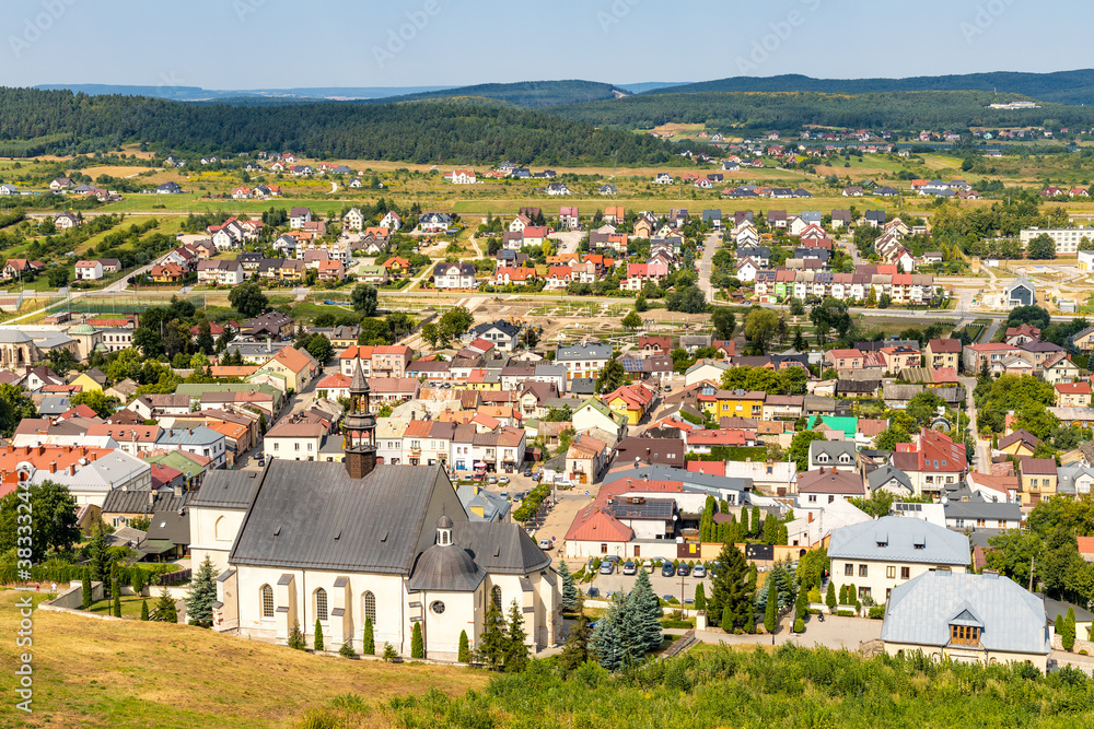 Panoramic view of town Checiny in Swietokrzyskie Mountains, with St. Bartholomew Church at slope of Royal Castle medieval fortress near Kielce in Poland