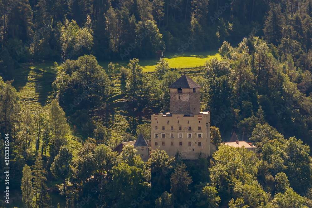 Aerial view of Landeck Castle, the emblem of the city of Landeck, Austria, surrounded by greenery and trees