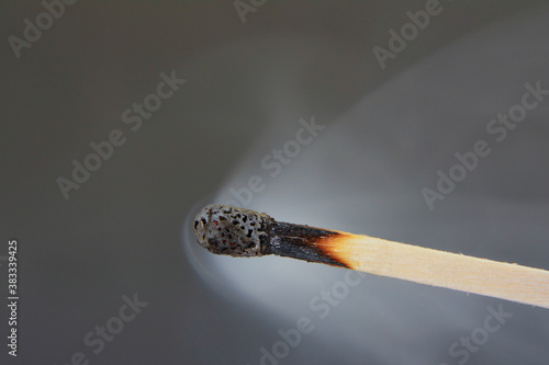 Extinguished phosphor pours smoke with gray background photo